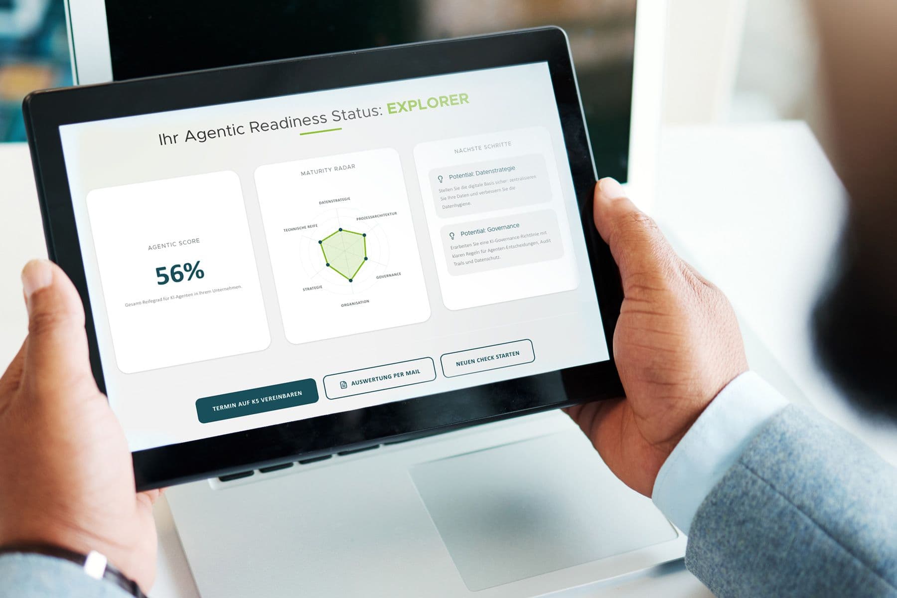Person hält Tablet mit Dashboard „Agentic Readiness Status: Explorer“. Angezeigt werden ein Score von 56 %, ein Radar-Diagramm zu Strategie, Governance und Organisation sowie empfohlene nächste Schritte und Aktionsbuttons unten.