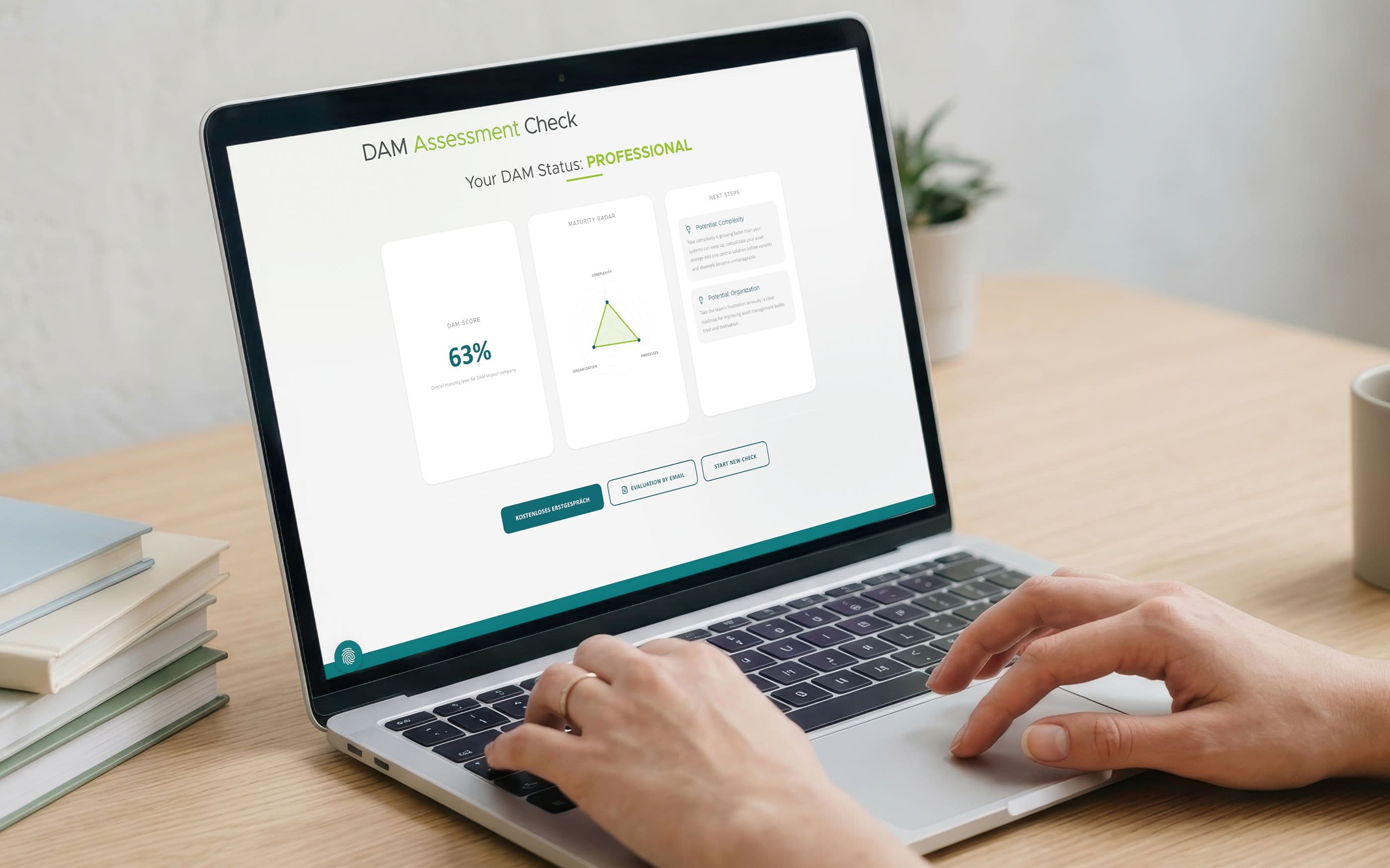A person is working on a laptop at a desk. The screen displays a “DAM Assessment Check” with the status “Professional,” a score of 62%, a radar chart, and recommendations for action.