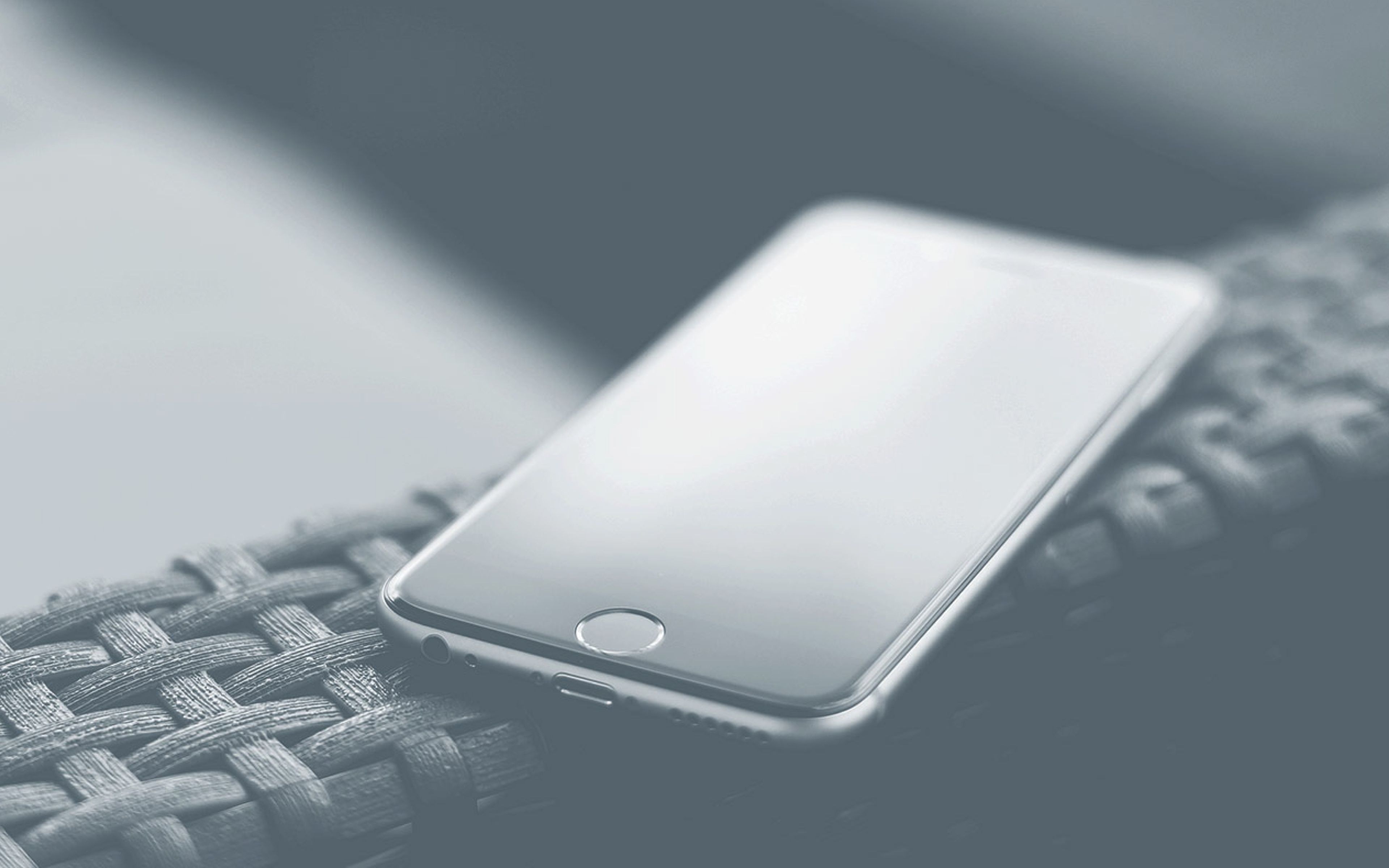 Photo of a cell phone on the arm of a sofa