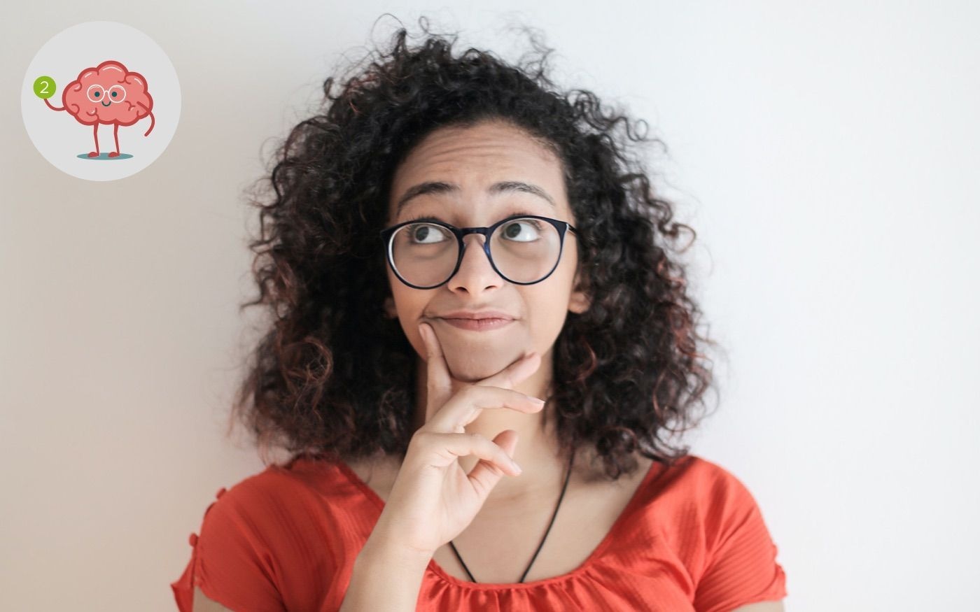 Photo of a woman looking toward the top left corner. In the corner is a graphic depicting a stylized brain as a man.