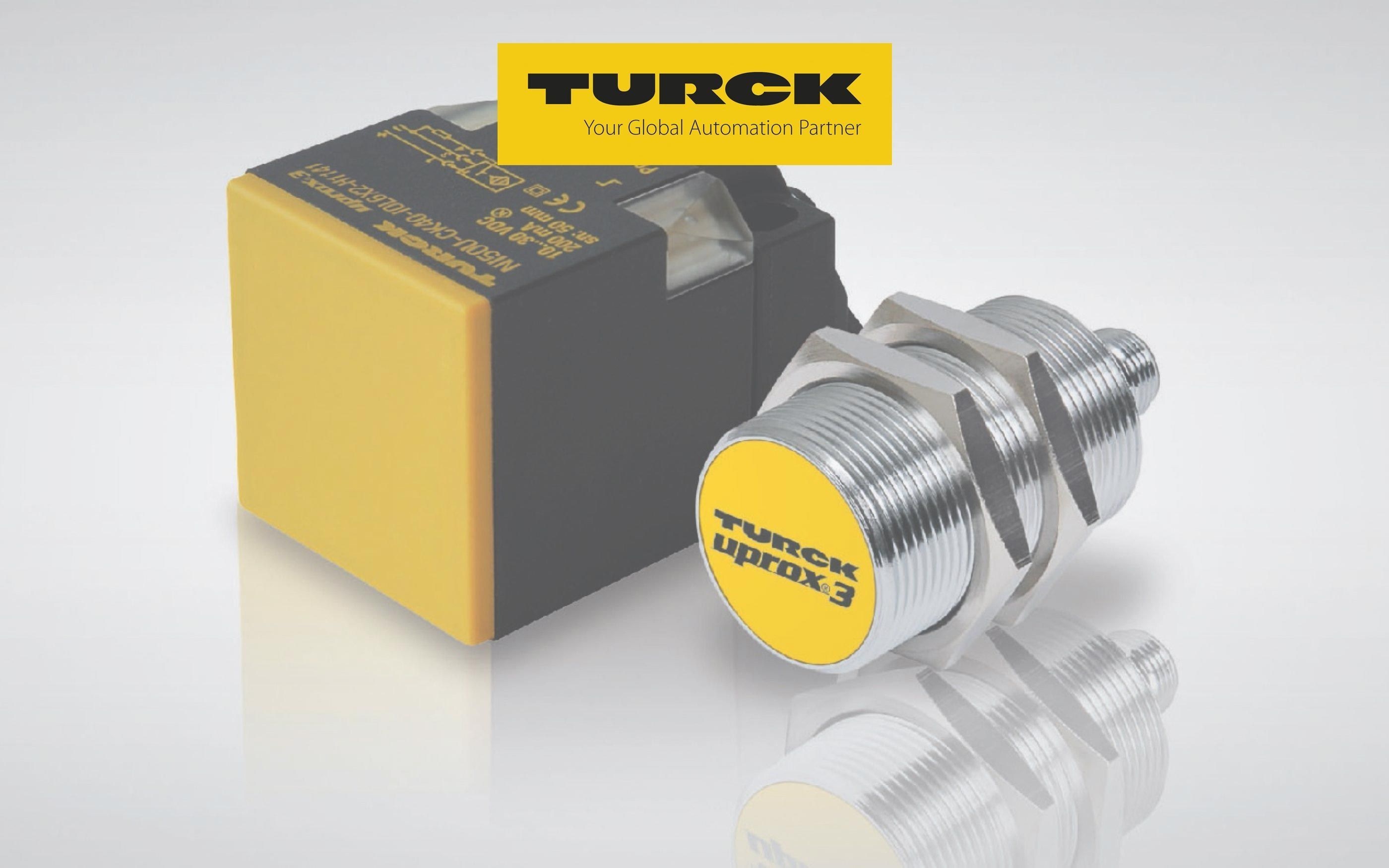 Product photo with two Turck sensors: left a yellow-black rectangular module, right a cylindrical metal inductive sensor with yellow front and imprint ‘Turck uprox3’; above the Turck logo with slogan ‘Your Global Automation Partner’.